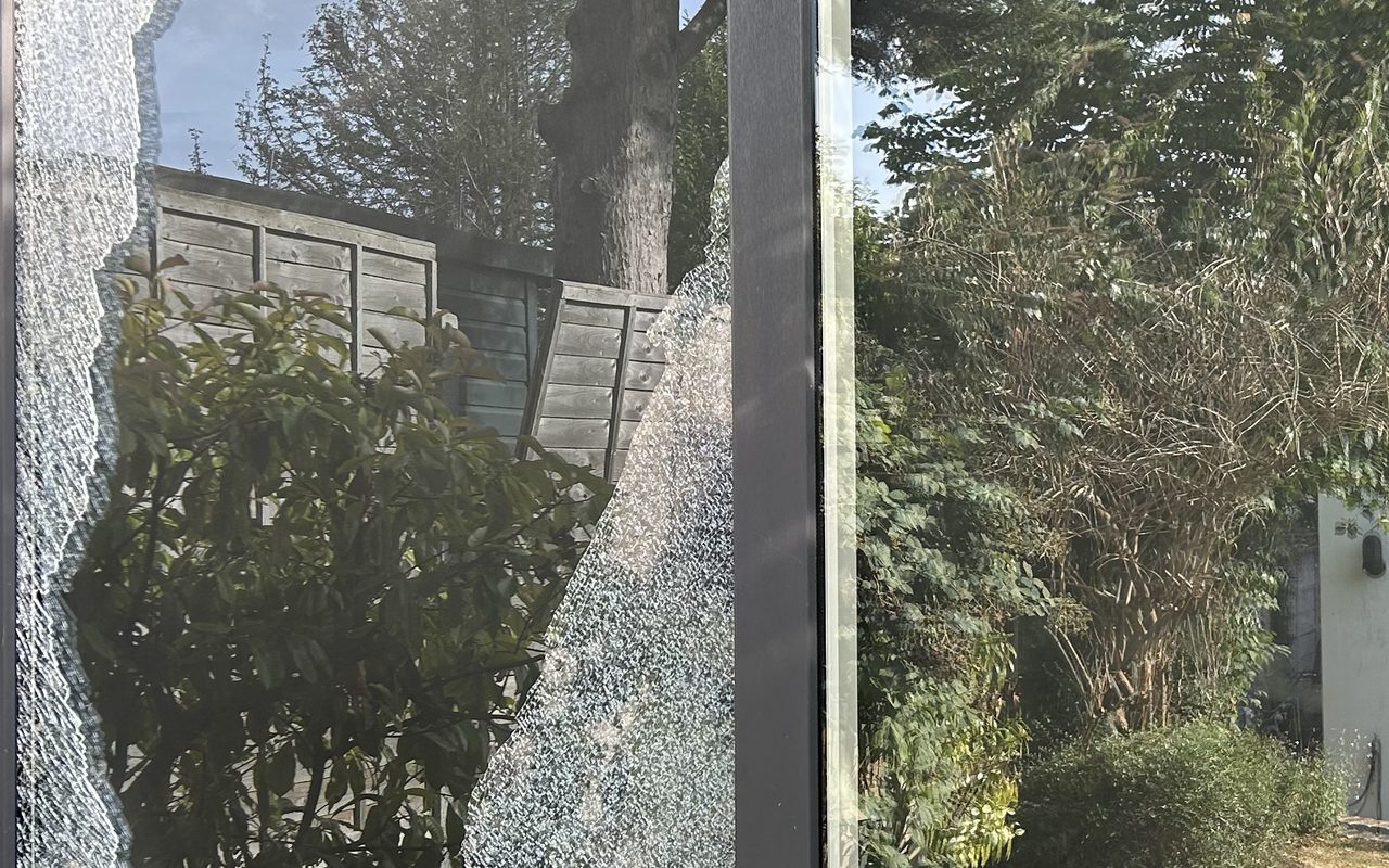 Smashed toughened glass in a sliding patio door awaiting emergency replacement