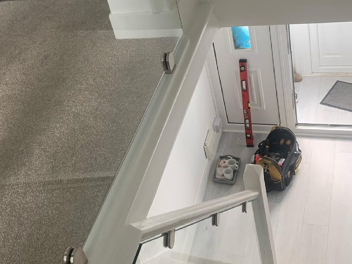 Glass balustrade fitted to a first-floor landing during installation
